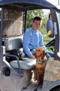 Rookery Farm staff member with a farm dog